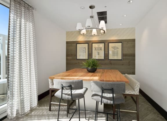 a dining room with a wooden table and chairs