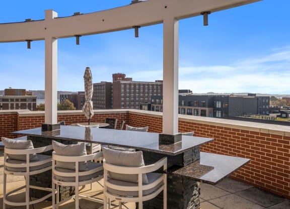 a patio with a table and chairs on top of a roof