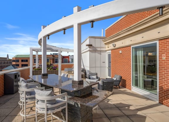 the private terrace of the building has a table and chairs