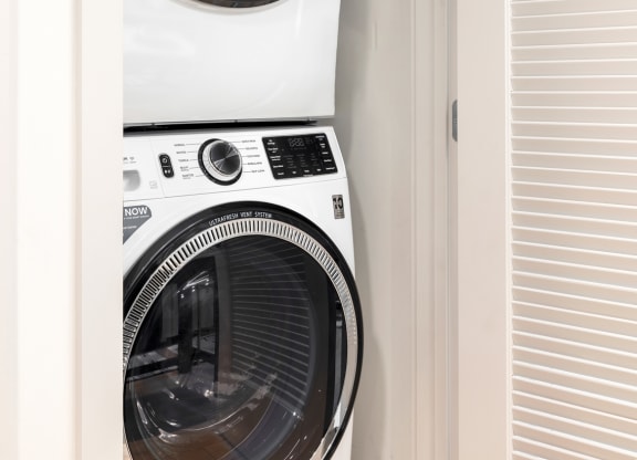 a white washer and dryer in a closet