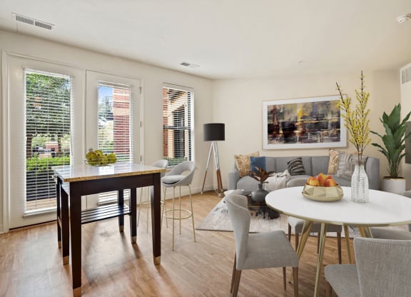 Photo of a sunlit living area with oversized windows and abundant natural light.