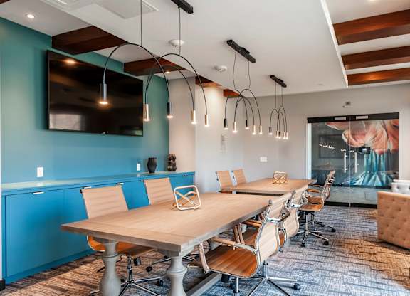 A conference room with a long table and chairs.