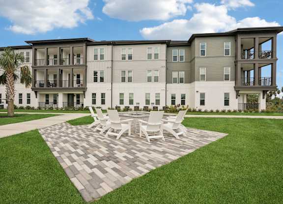 Exterior of The Crossing at Palm Aire with fire pit and seating