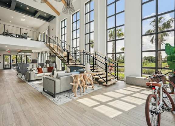 Clubhouse with furniture, stairs to the second floor, and miscellaneous decor
