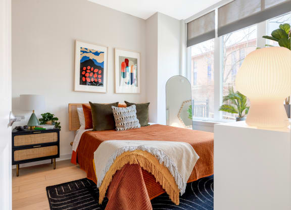 a bedroom with a bed and a large window