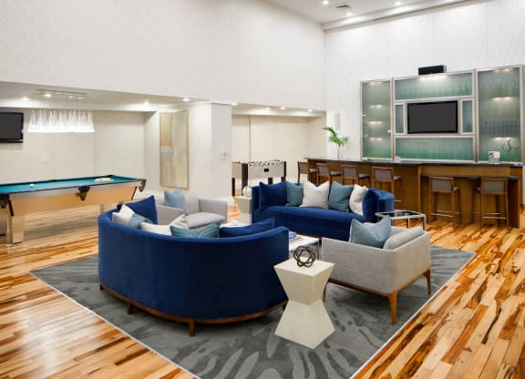 a living room with couches and a pool table