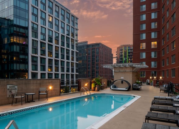 a swimming pool in the middle of two tall buildings