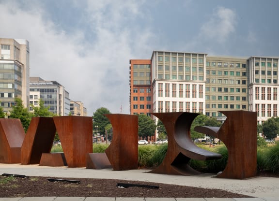 a large sculpture in front of some buildings