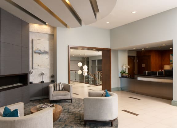 a living room with couches and chairs and a fireplace
