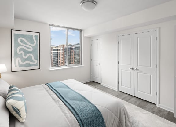 a bedroom with a large bed and a window