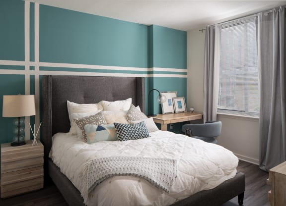 a bedroom with a bed and a desk with a chair