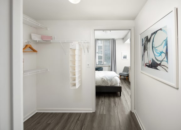 a bedroom with a large mirror and a closet with a bed