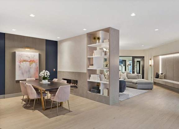 A modern dining room with a wooden table and chairs.