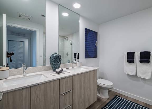 A bathroom with a white sink and a toilet.