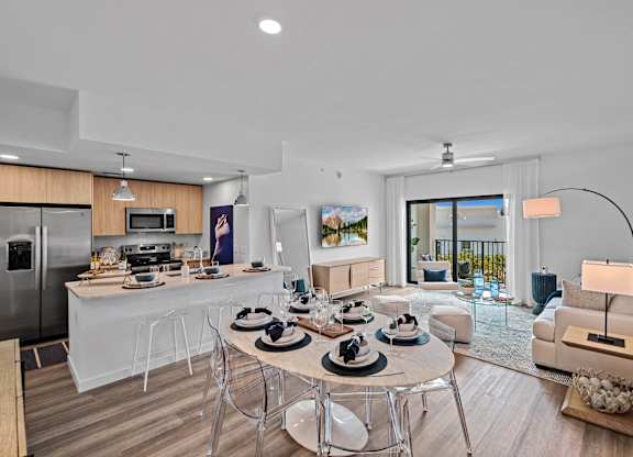 A modern kitchen with a dining table set for four.
