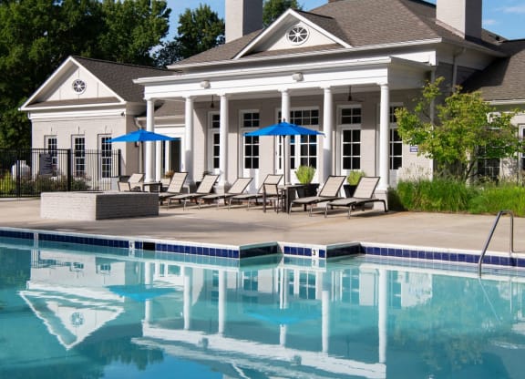 a house with a swimming pool in front of it