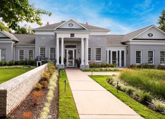 a large house with a walkway leading up to the front door