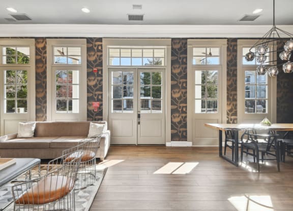 a living room filled with furniture and a large window
