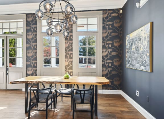 a dining room with blue walls and a large chandelier