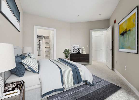 A bedroom with a bed, nightstand, and a painting on the wall.