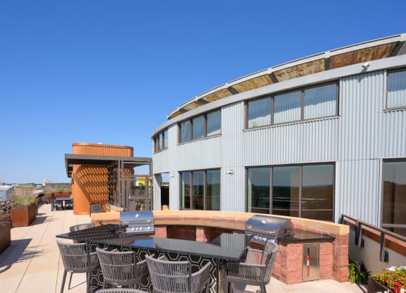 a patio with a table and chairs outside of a building