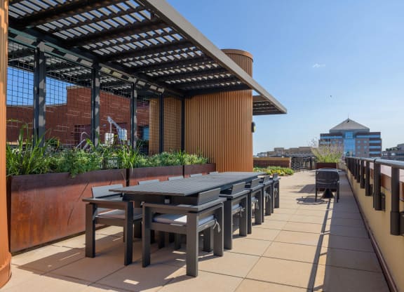 a terrace with tables and chairs on a roof