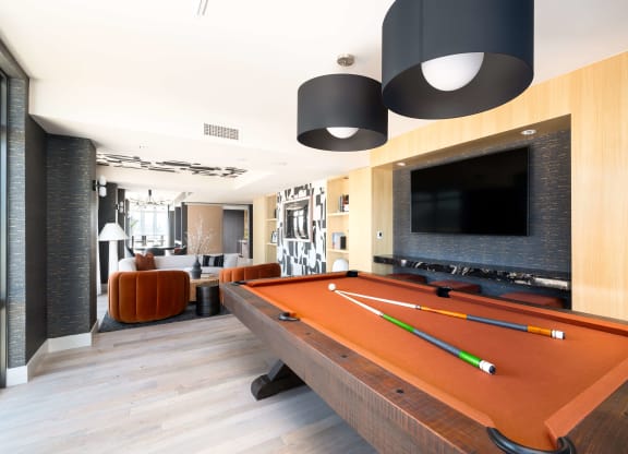 a pool table in a living room with a tv
