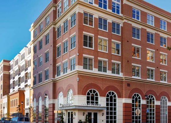 A large red brick building with white trim and arched windows.