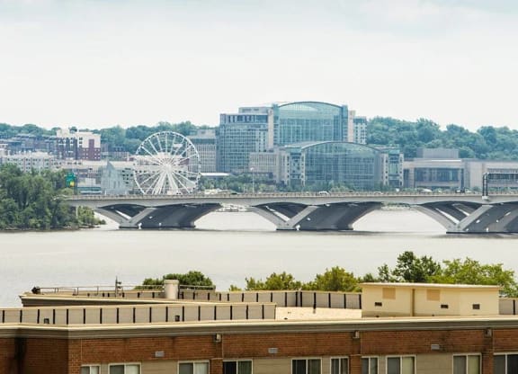 A bridge over a body of water with a building in the foreground.