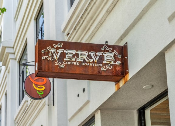 a sign for a coffee shop on the side of a building