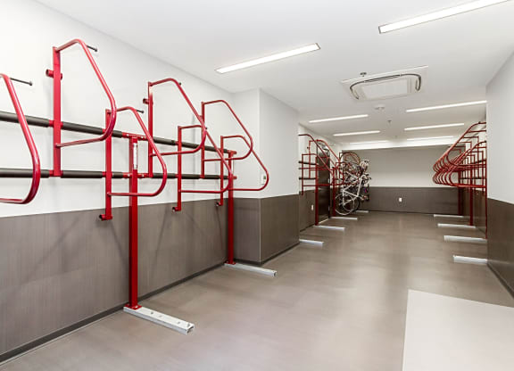 a row of red bike racks in a white walled room