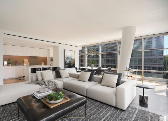 Spacious apartment living room showing kitchen