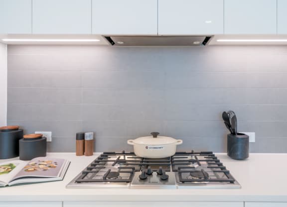 a kitchen with a stove and a pot on top of it