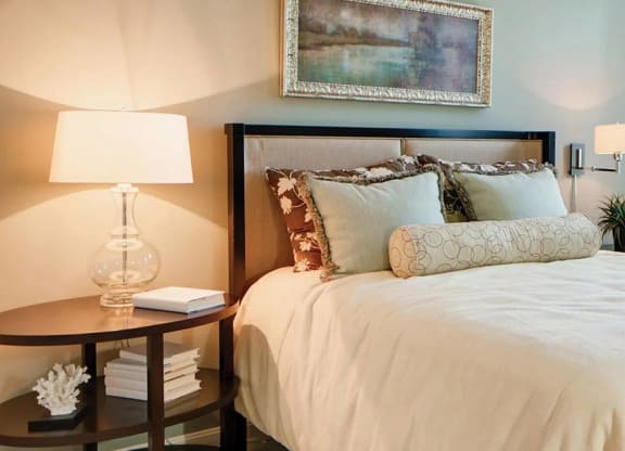 Bedroom with a cozy bed next to large windows covered in sheer drapery at Chesapeake Ridge, North East, MD, 21901