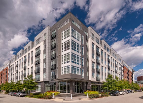 a gray and white building with a blue sky in the background