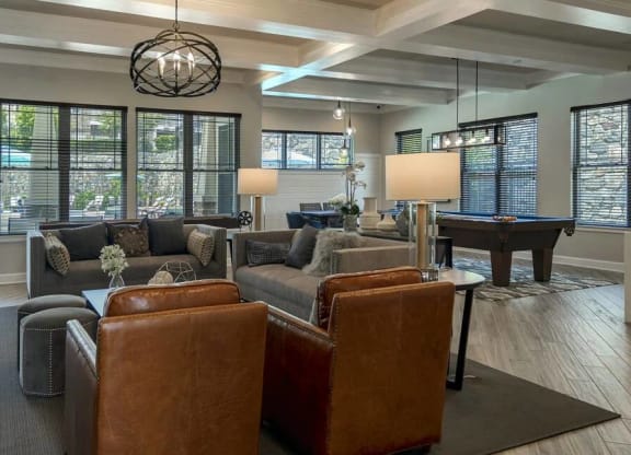 Game Lounge with Cozy seating, a fireplace, white framed ceilings,  and plank flooring at Chesapeake Ridge, North East, MD
