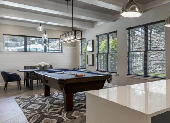 Game lounge with Billiards table, paisley patterned run, and plank flooring with a marble demo kitchenette in front at Chesapeake Ridge, North East, MD, 21901