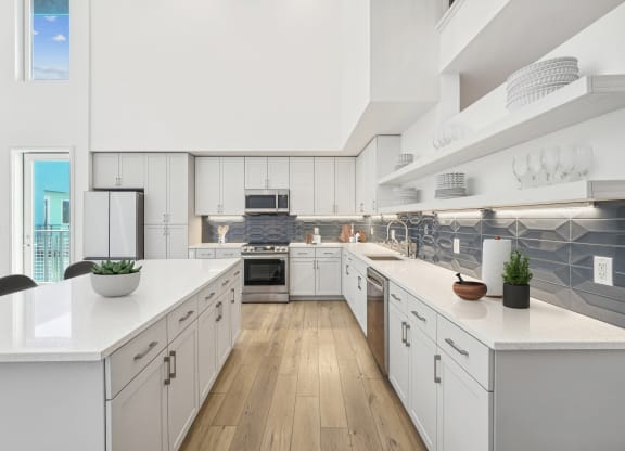 a large kitchen with white cabinets and white counter tops