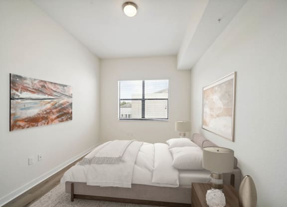 an image of a bedroom with a bed and a window