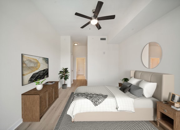 a bedroom with a large bed and a ceiling fan