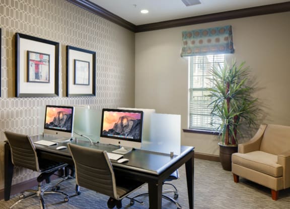 two computers sitting on a desk in a room