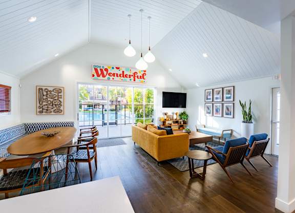 A living room with a white ceiling and a sign that says "Wonderful".