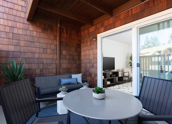 A patio with a table and chairs.