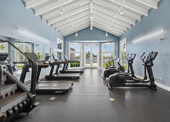fitness center with treadmills and ellipticals