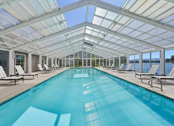 greenhouse-style pool house with swimming pool