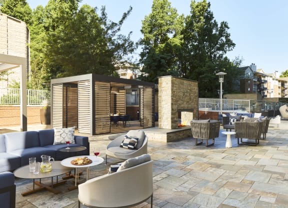 a rendering of a patio with couches and chairs and tables