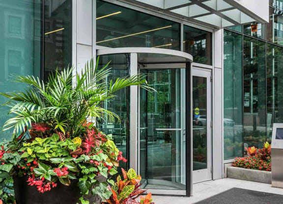 a glass revolving door in front of a building