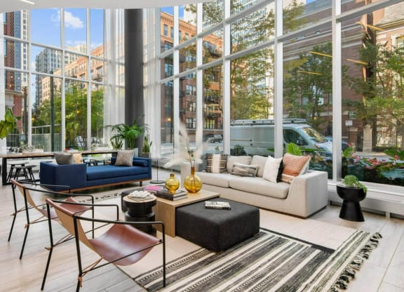 a living room with a large window and a view of a city