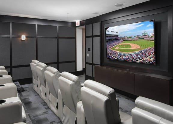 a room filled with white chairs and a flat screen tv