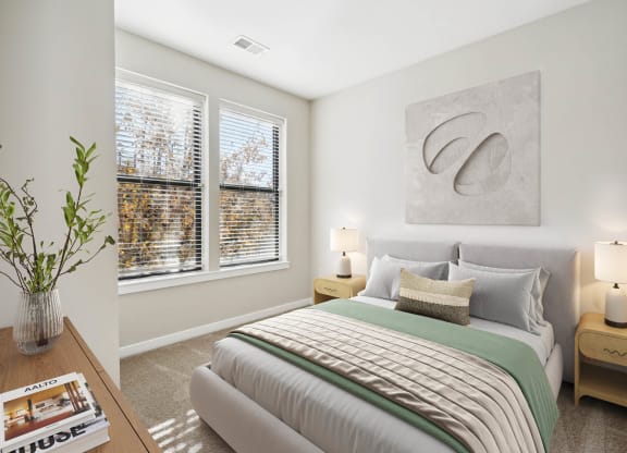 a bedroom with a bed and two windows
